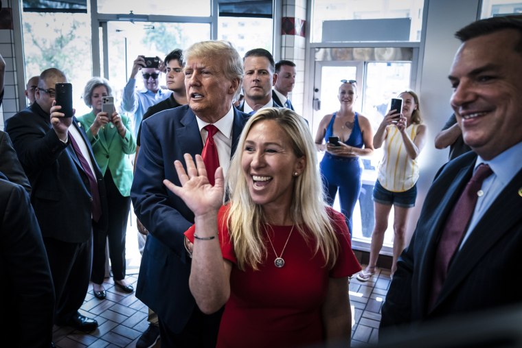 Former President Donald Trump arrives a Waffle House with Rep. Marjorie Taylor Greene