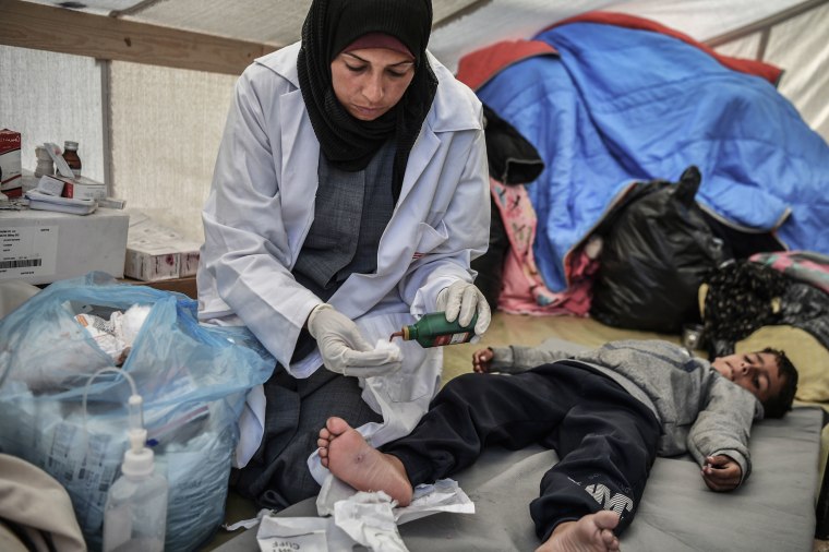 Doctor Fida Atiyya al-Girshalli provides medical service for the Palestinians who live in tents after being displaced from Shujaiyye city to Rafah as they try to continue their lives under harsh conditions amid Israeli attacks in Rafah, Gaza on Jan. 9, 2024.