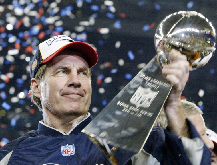 Bill Belichick holds the Vince Lombardi trophy.