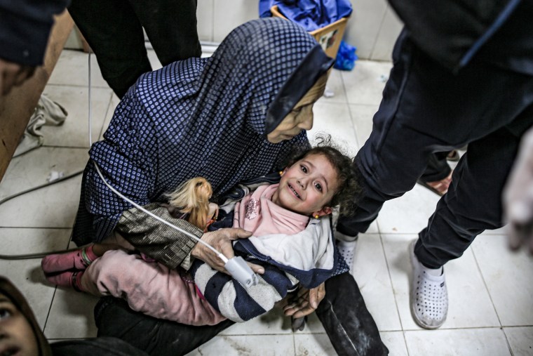  Injured Palestinians, including children are taken to the Nasser Hospital following an Israeli strike on the house of the Abu Aram family in Khan Younis, Gaza, on Jan. 12, 2024.