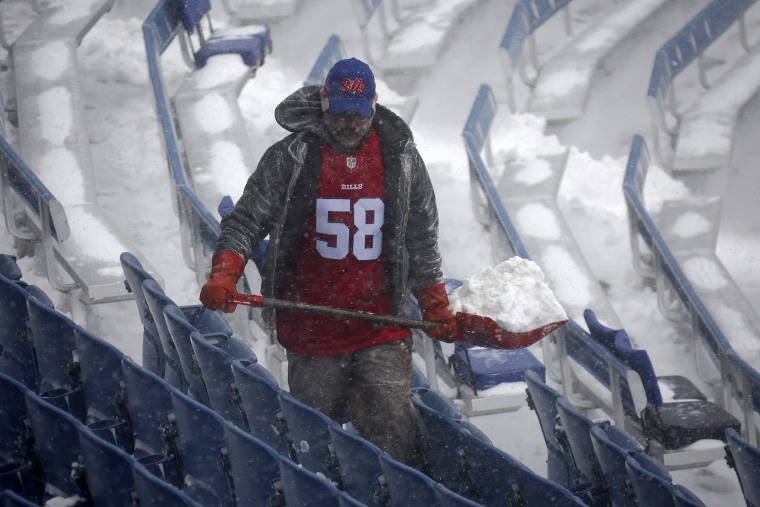 A worker helps remove snow from Highmark Stadium in Orchard Park, N.Y., Sunday, Jan. 14, 2024. A potentially dangerous snowstorm that hit the Buffalo region on Saturday led the NFL to push back the Bills wild-card playoff game against the Pittsburgh Steelers from Sunday to Monday. New York Gov. Kathy Hochul and the NFL cited public safety concerns for the postponement, with up to 2 feet of snow projected to fall on the region over a 24- plus hour period.Image: