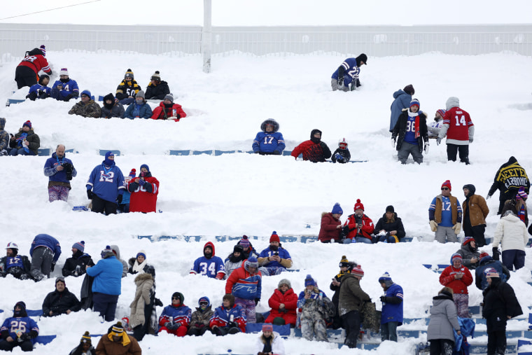 Fans take their seats in the snow before the game between the Buffalo Bills and the Pittsburgh Steelers.