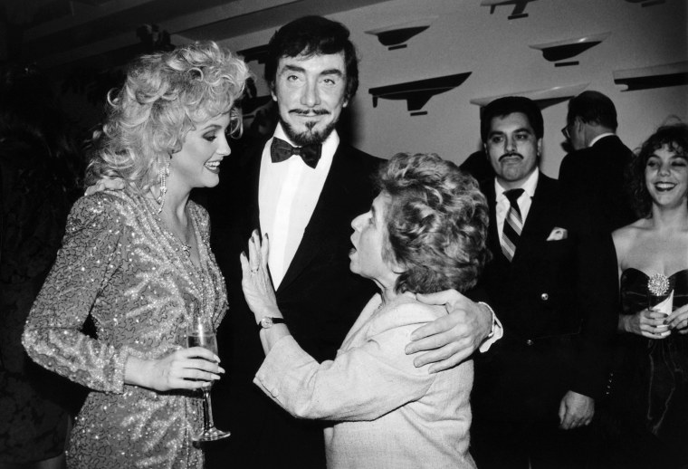 New "Penthouse Pet of the Year" Ginger Miller chats with Dr. Ruth Westheimer while Penthouse publisher Bob Guccione looks on at a party in Ms. Miller's honor in New York in 1988.