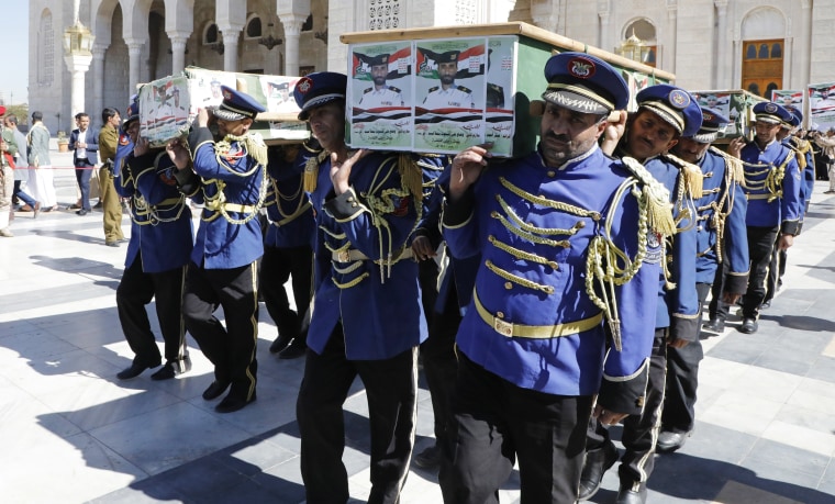 A Houthi honor guard carries the coffins of fighters killed in the U.S. and U.K. air strikes in Yemen during their funeral Sunday, Jan. 14, 2024. 