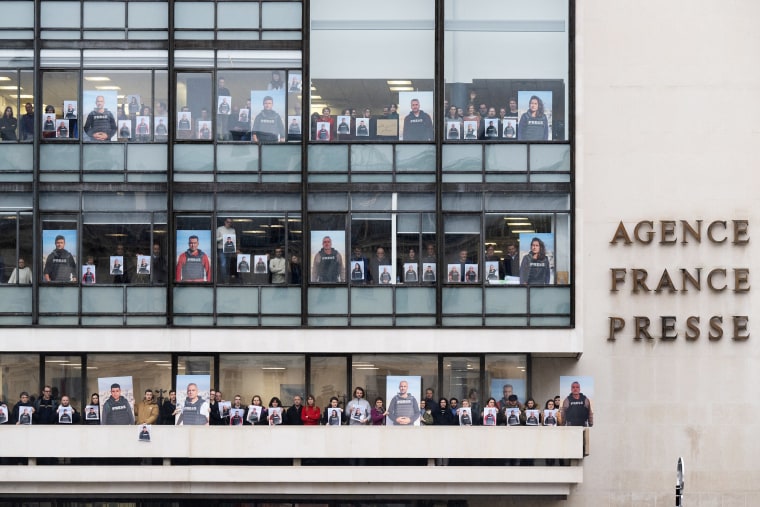 AFP journalists hold portraits on Paris balcony