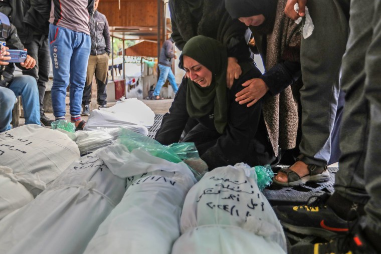 Mourners collect the bodies of friends and relatives killed in an airstrike on Jan. 17, 2024 in Rafah, Gaza. 