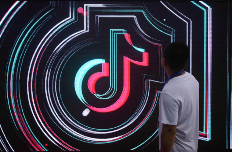 A man walks by a sign forf TikTok at an e-commerce expo in Hangzhou, China,