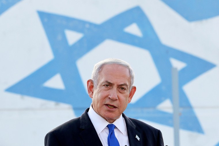 Benjamin Netanyahu in front of Israel flag. 