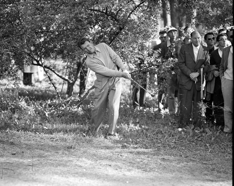 Jack Burke Jr. hits from under a dogwood tree along 15th fairway during final round of the Masters Golf Tournament at the Augusta National Golf Course in Augusta, Ga., April 8, 1956.  Burke surged into the lead to win the tournament with a 72-hole total of 289 after front runner Cary Middlecoff and Ken Venturi faltered on last day.