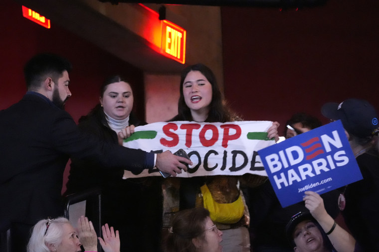 A protester interrupts President Joe Biden during an event today on the campus of George Mason University in Manassas, Va.