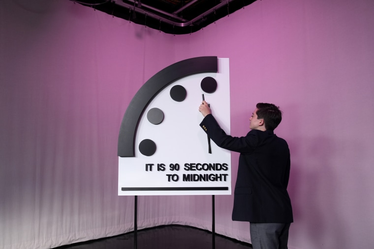 A staffer shows the location of the minute hand on the "Doomsday Clock", in Washington, D.C., on Jan. 23, 2024. 
