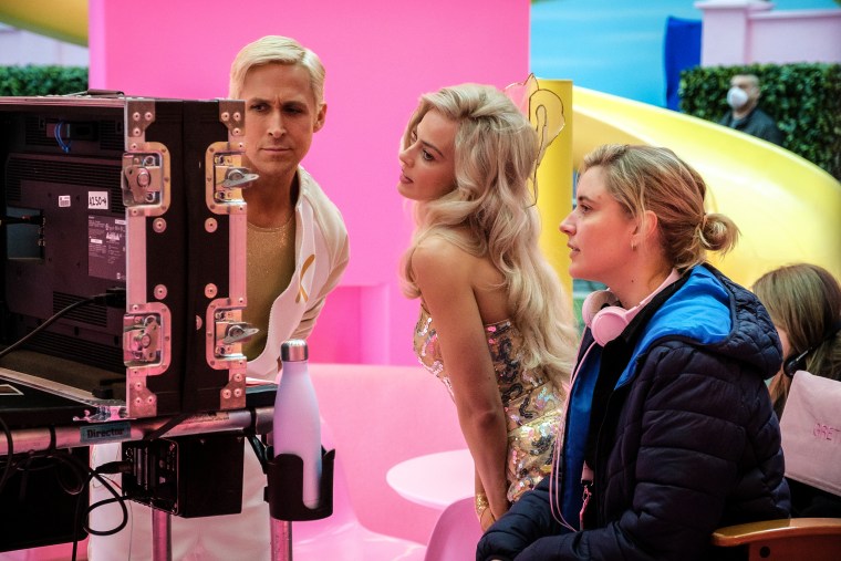 Ryan Gosling, left, Margot Robbie, center, with director Greta Gerwig on the set of "Barbie."