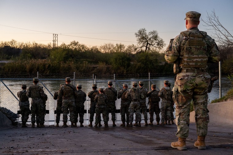 National Guard soldiers stand guard on the banks of the Rio Grande River at Shelby Park on January 12, 2024, in Eagle Pass, Texas. 