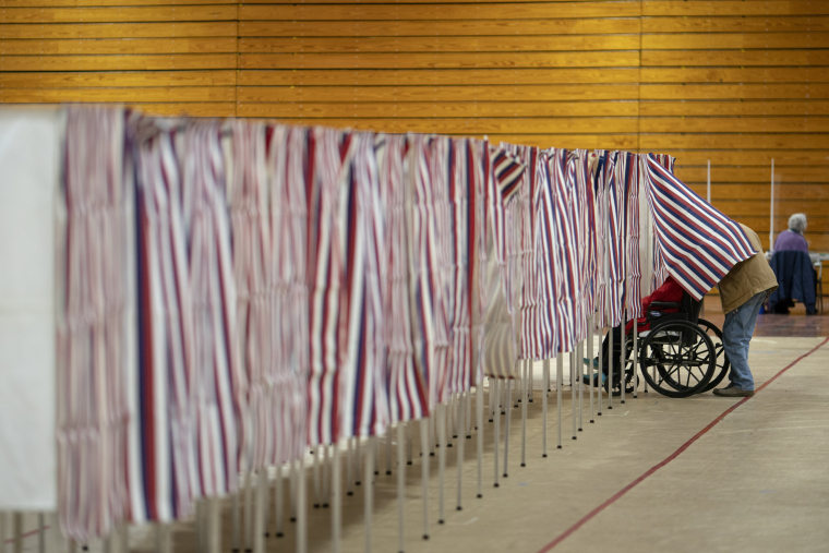 A voters leaves a booth after casting a ballot in the New Hampshire presidential primary at a poling site in Derry, N.H., Tuesday, Jan. 23, 2024. 
