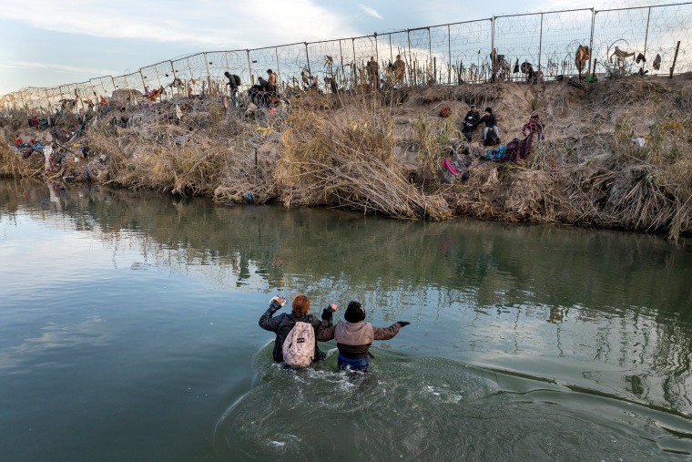 An aerial view of migrants crossing the Rio Grande.