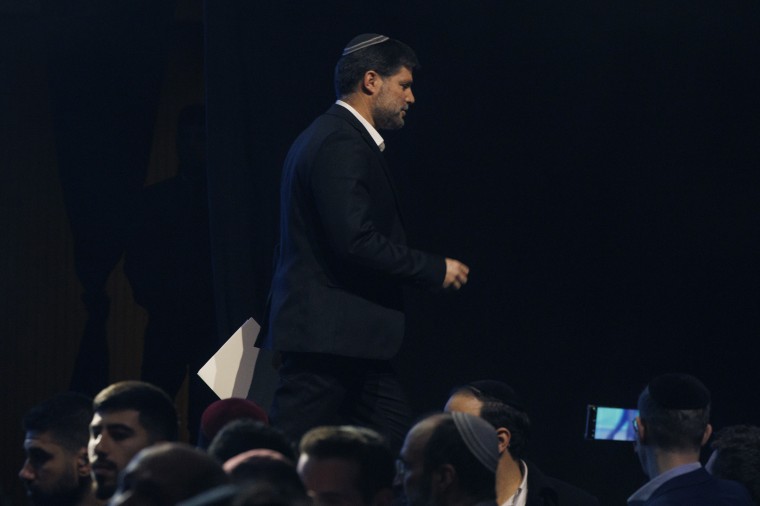 Israeli Finance Minister Bezalel Smotrich leaves the stage of the conference on Sunday.