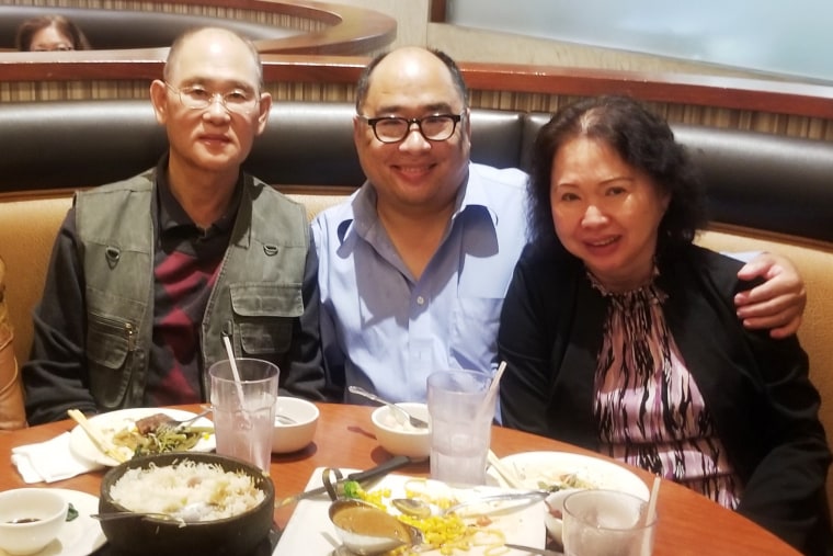 Andy Kao, Francois Ung, and Shally Ung. pose for a photo at a restaurant.