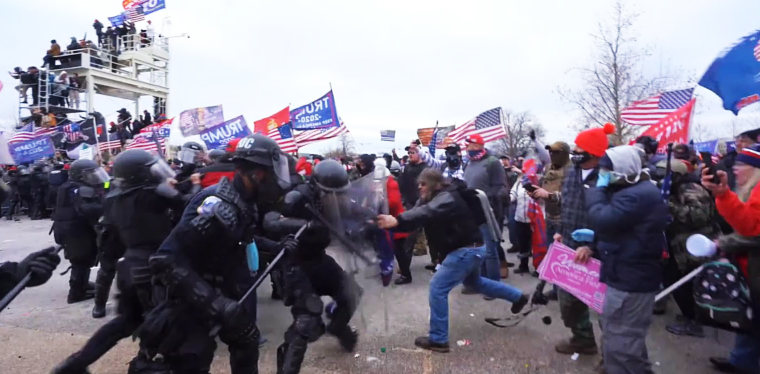 Ralph Celentano uses their riot shields against police at the Capitol on Jan. 6, 2021.