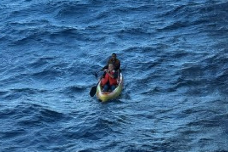The two stranded men on a kayak before being rescued.