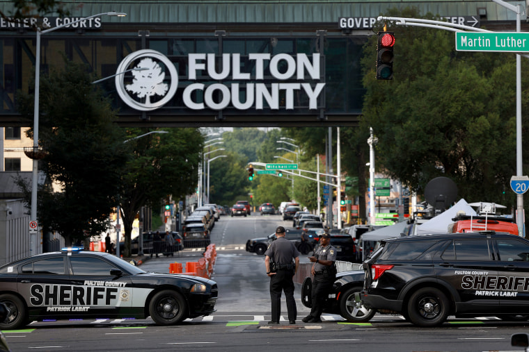 Fulton County Sheriff officers block off a street in front of the Fulton County Courthouse