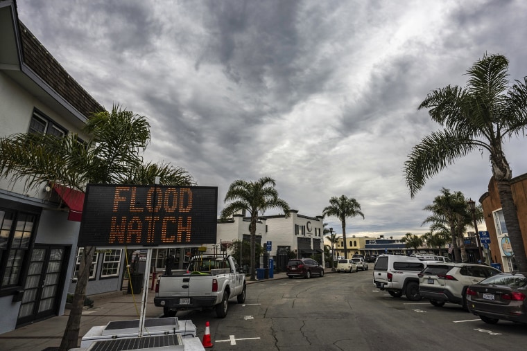 Image: A sign warns of potential flooding in Capitola Village
