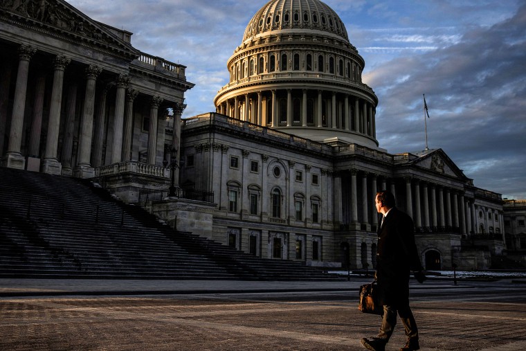 Image: A man walks past the Capitol building on Jan. 23, 2024.