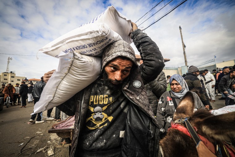 Displaced Palestinians receive food aid at the UNRWA center in Rafah, southern Gaza, on Jan. 28, 2024.