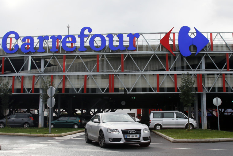 A car leaves a Carrefour supermarket on Jan. 23, 2018. 