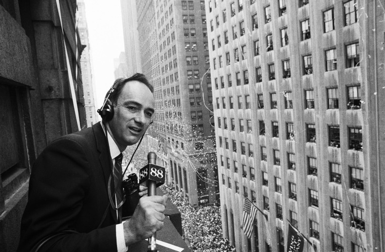 Charles Osgood leans over a ledge during the Ticker Tape Parade in New York City for Apollo 11 astronauts "Welcome To New York". New York, New York, August 13, 1969. 
