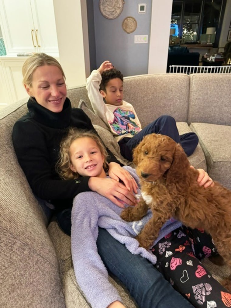 Craig Melvin's new dog cozies up next to his family on the couch.