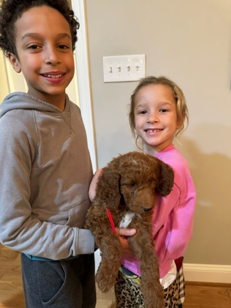Craig Melvin's kids hold their new puppy named Myles.