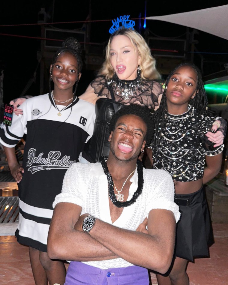 Madonna poses with three of her kids, David, Stella and Estere, at a New Year's Eve celebration.