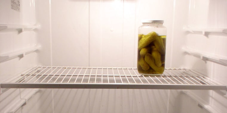 lone pickle jar in an empty fridge
