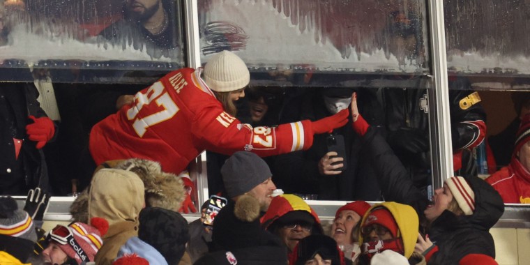 Taylor Swift celebrates by high-fiving Beth Vancil at the Chiefs-Dolphins game.