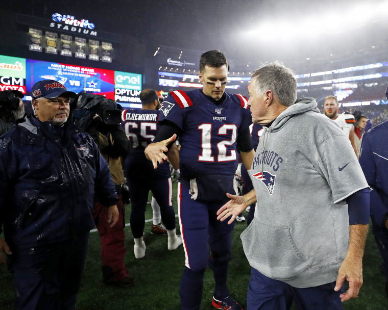 Tom Brady #12 of the New England Patriots congratulates head coach Bill Belichick