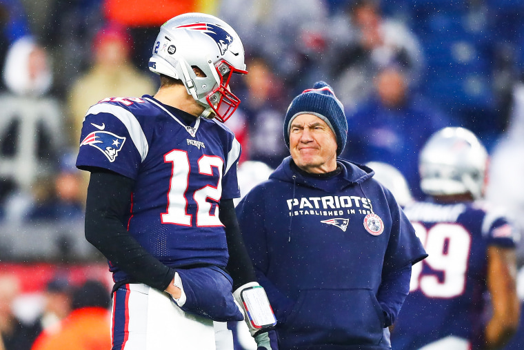 Tom Brady #12 talks to head coach Bill Belichick 