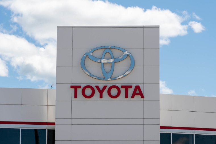 A Toyota sign on car dealer during the daytime. The sky is
