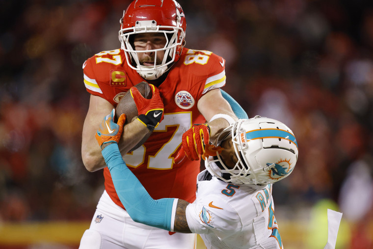 Travis Kelce #87 of the Kansas City Chiefs stiff arms Jalen Ramsey #5 of the Miami Dolphins during the third quarter in the AFC Wild Card Playoffs at GEHA Field at Arrowhead Stadium on January 13, 2024 in Kansas City, Missouri. 