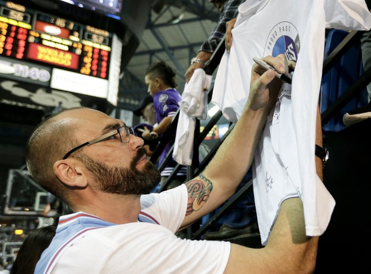  Former Sacramento Kings player Scot Pollard signs an autograph during the half time of the Kings NBA basketball game against the Oklahoma City Thunder, in Sacramento, Calif. on April 9, 2016. 