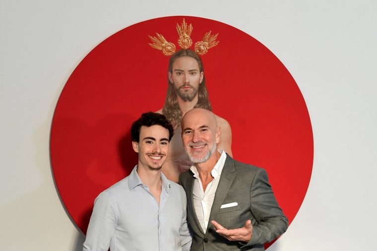 Artist Salustiano Garcia poses in front of a painting with his son and model Horacio.