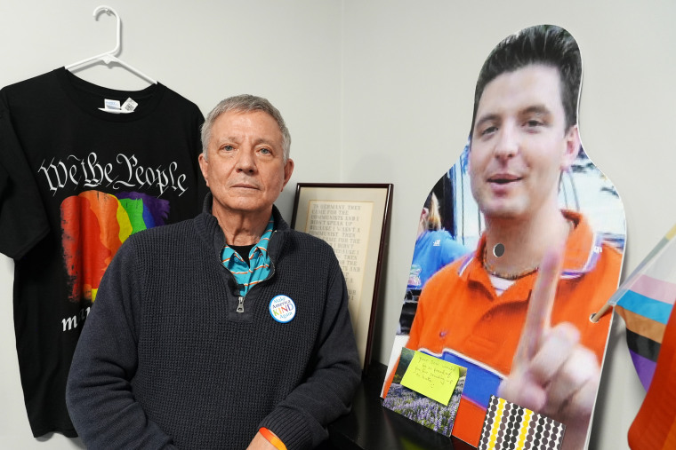 Littleton Town Manager Jim Gleason alongside a cutout of his late son, Patrick Gleason.