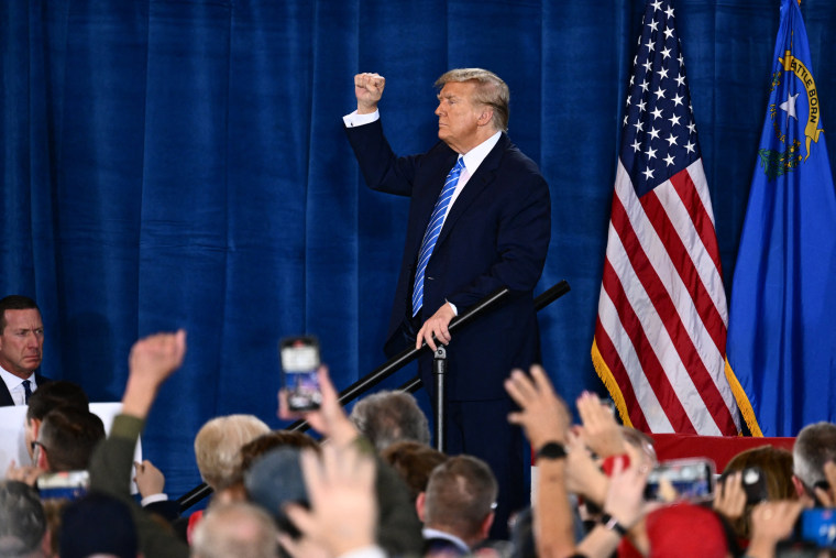 Donald Trump raises his fist as he leaves after speaking at a Commit to Caucus Rally in Las Vegas.