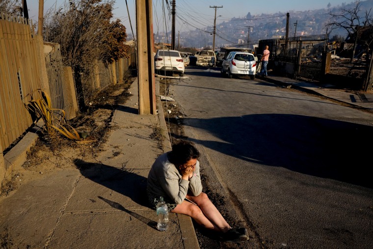 A woman cries after a friend died in the wildfire.