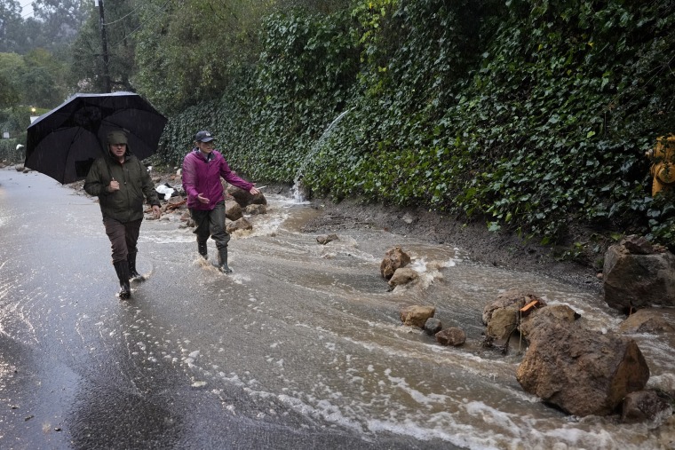 Water gushes down Lockridge Rd. during a storm Monday, Feb. 5, 2024, in Studio City in Los Angeles, Calif. 