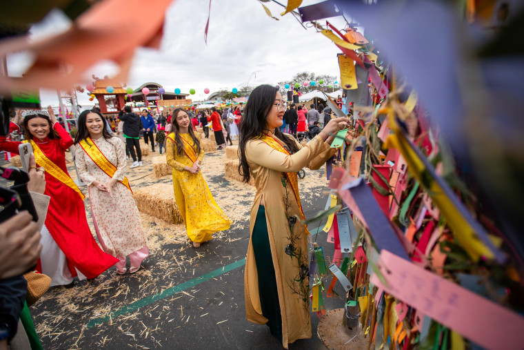 Michelle Ngo hangs her wish on the wishing tree at the 41st Union of The Vietnamese Student Association Tet Festival at the Orange County Fair & Events Center in Costa Mesa, Calif., last year.