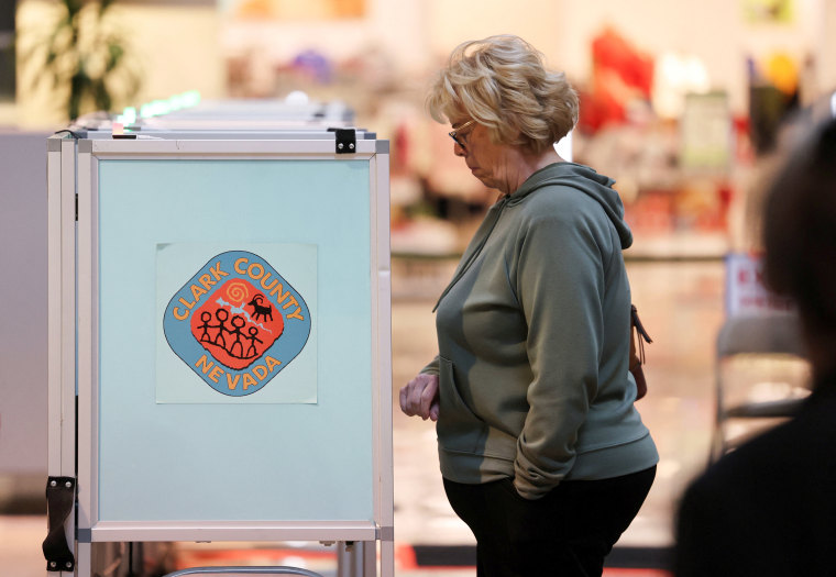 A voter casts her ballot in the state's Democratic and Republican presidential primary election in Las Vegas