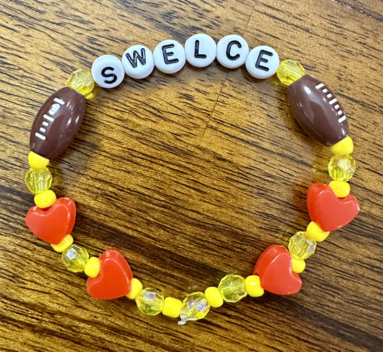 Bracelet with beads that spell out "Swelce" 