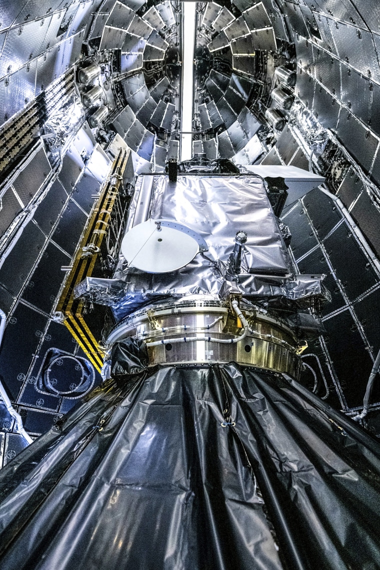 Image: NASA and SpaceX technicians encapsulating NASA's PACE (Plankton, Aerosol, Cloud, ocean Ecosystem) spacecraft 