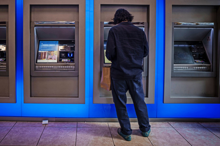 A customer uses an ATM in New York City. 