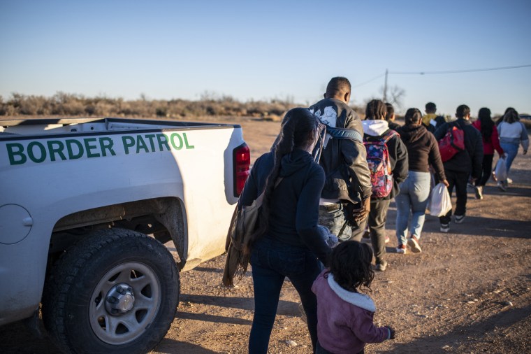 A group of migrants are processed by Border Patrol outside Eagle Pass, Texas.
